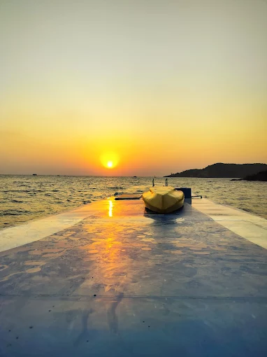 Golden sunset seen from the boat deck over still water